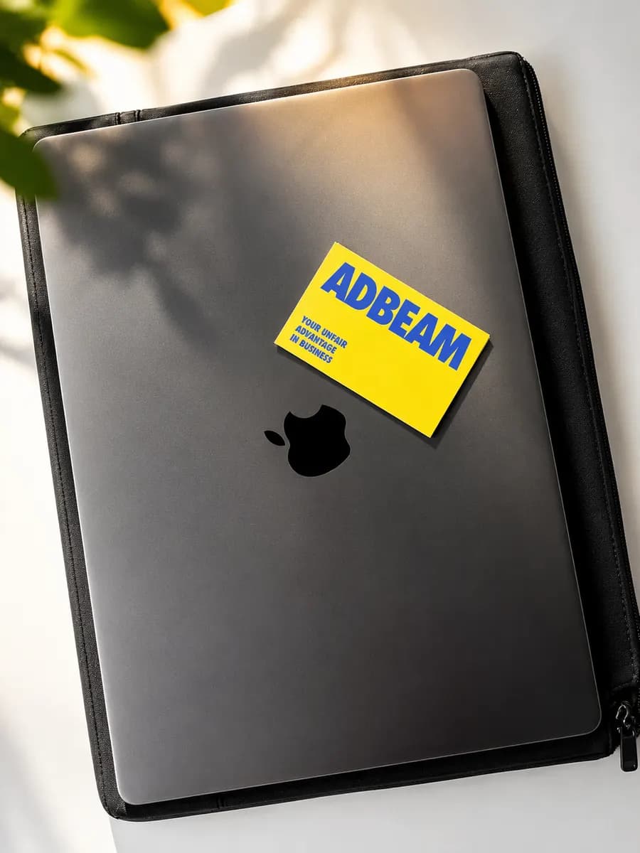 ADBEAM business card on a laptop